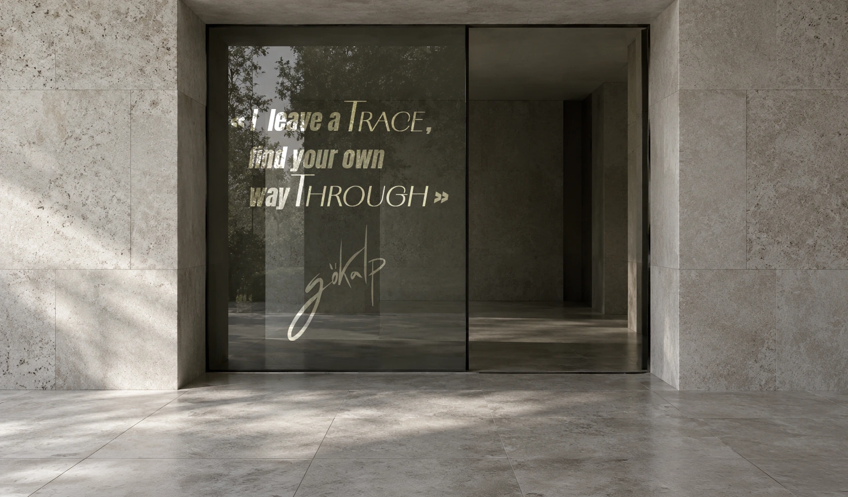 Stone and glass architecture bearing the inscription “I leave a trace, find your own way through” and Gökalp’s signature.